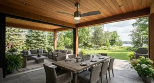 An energy-efficient indoor-outdoor ceiling fan cooling a combined dining and outdoor living space.