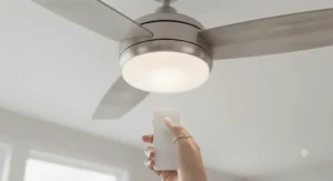Detailed view of the integrated dimmable LED light kit on a flush mount ceiling fan, controlled by a sleek remote with a maple leaf icon.