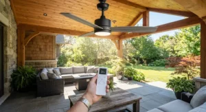 Remote-controlled smart wet rated ceiling fan operating on a sunny exterior patio space.