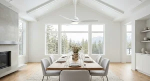 Minimalist white ceiling fan blending seamlessly into a bright, high-ceilinged modern Canadian dining room.